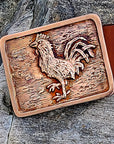 Rooster Buckle and belt shown with a stone background.